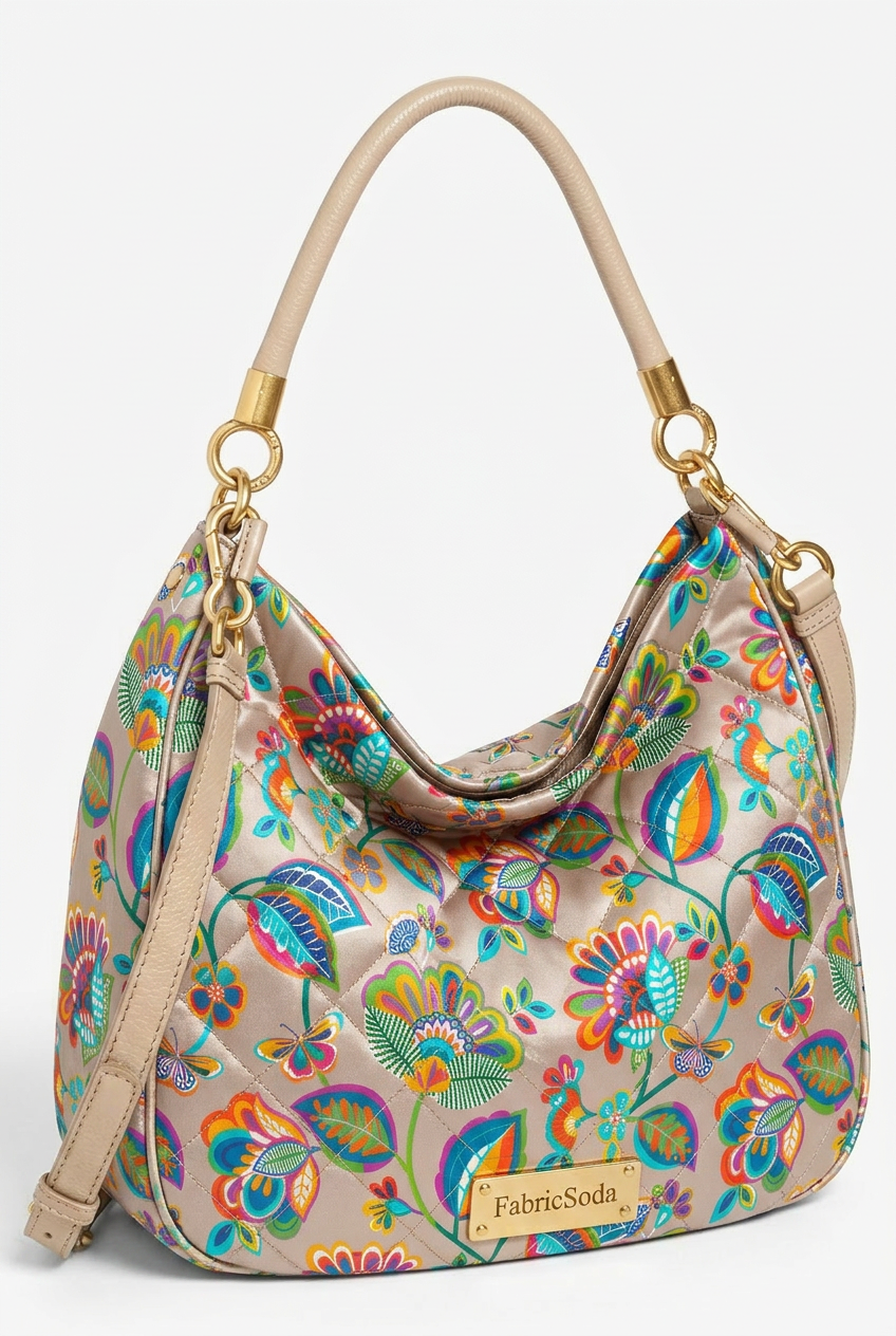 Colorful floral-patterned handbag with beige handle and strap on a white background